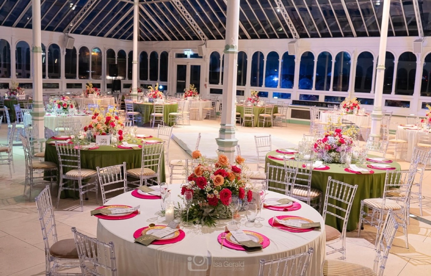 Round tables laid with florals and chiavari chairs for a gala dinner