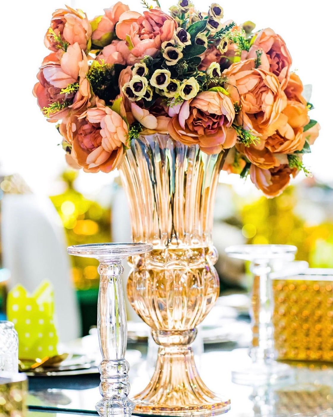An autumnal centrepiece of dahlias and roses in a crystal urn, New Year table styling