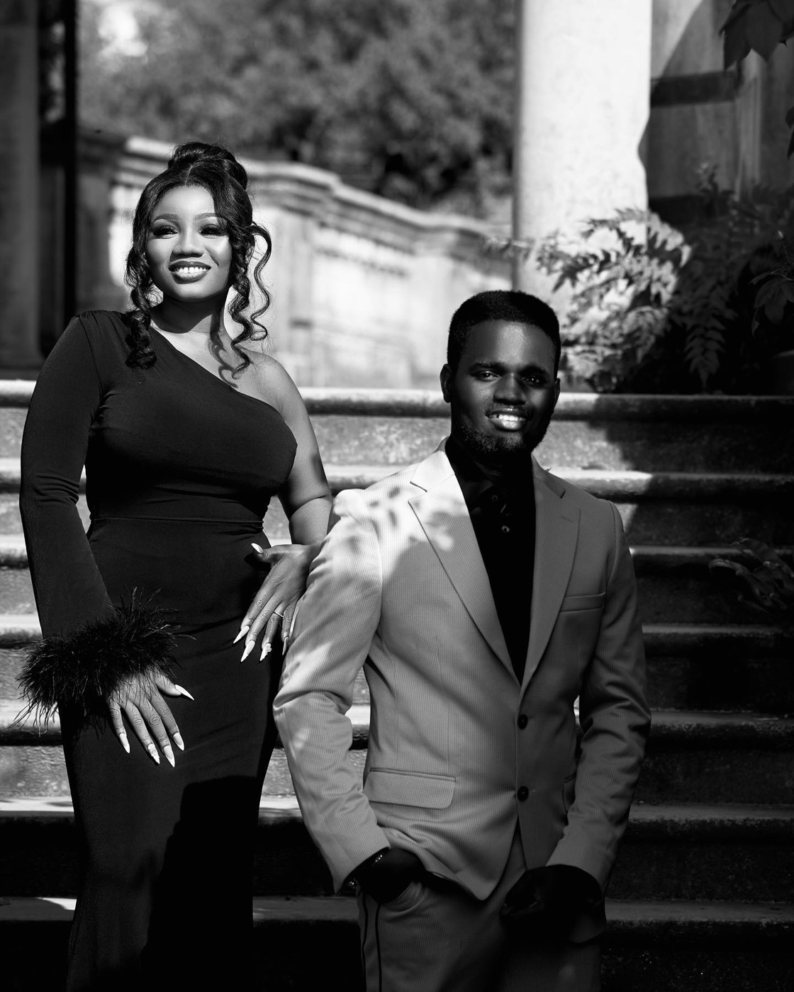 A couple in black and white formalwear, portrait on a stone staircase