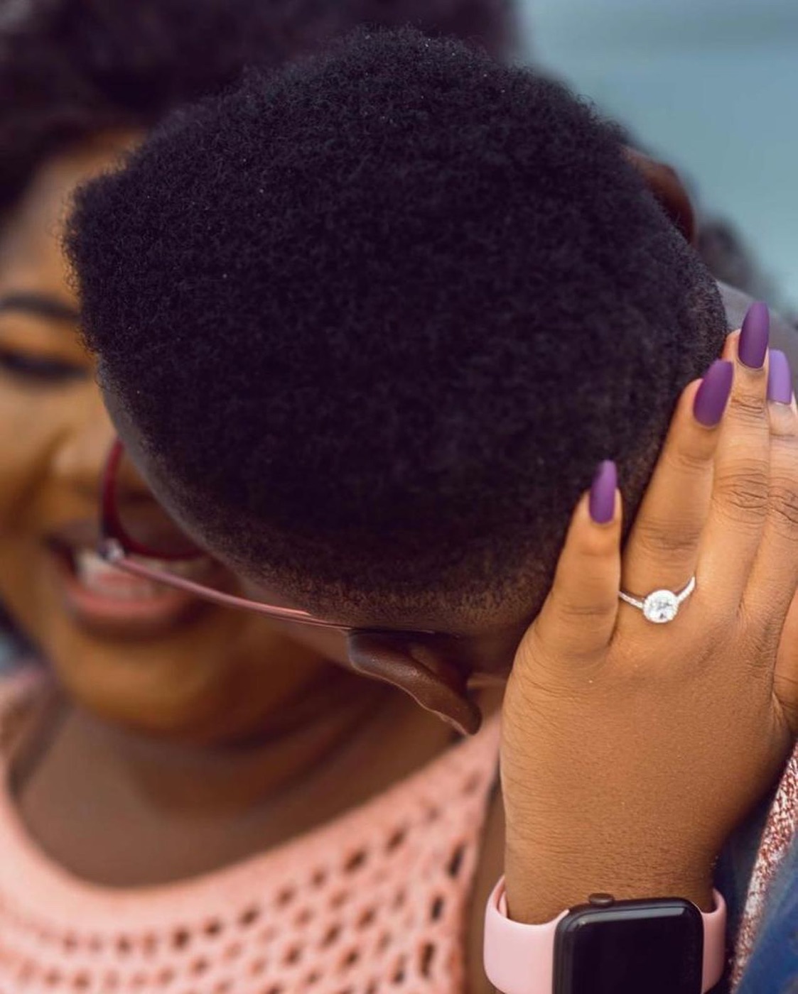 A bride laughing candidly with natural curls, caught mid-moment